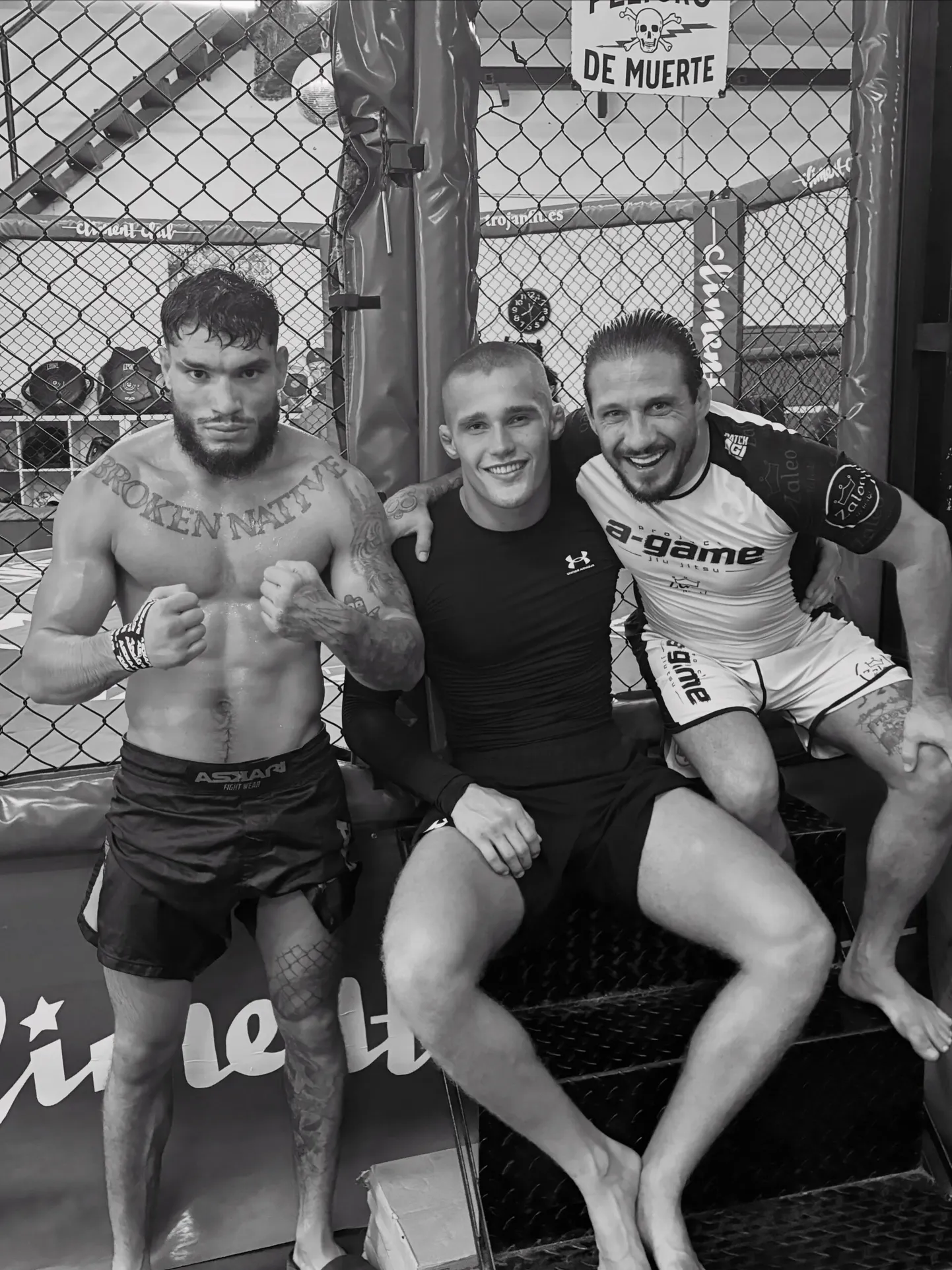 Moritz Barth sitzt mit zwei Trainingspartnern vor dem Käfig des Climent Club in Alicante.