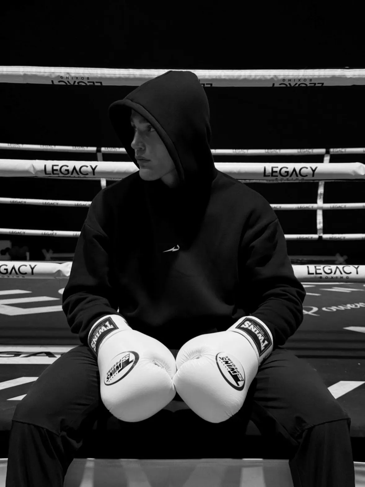 Moritz Barth sitzt konzentriert mit Kapuze und Boxhandschuhen im Ring